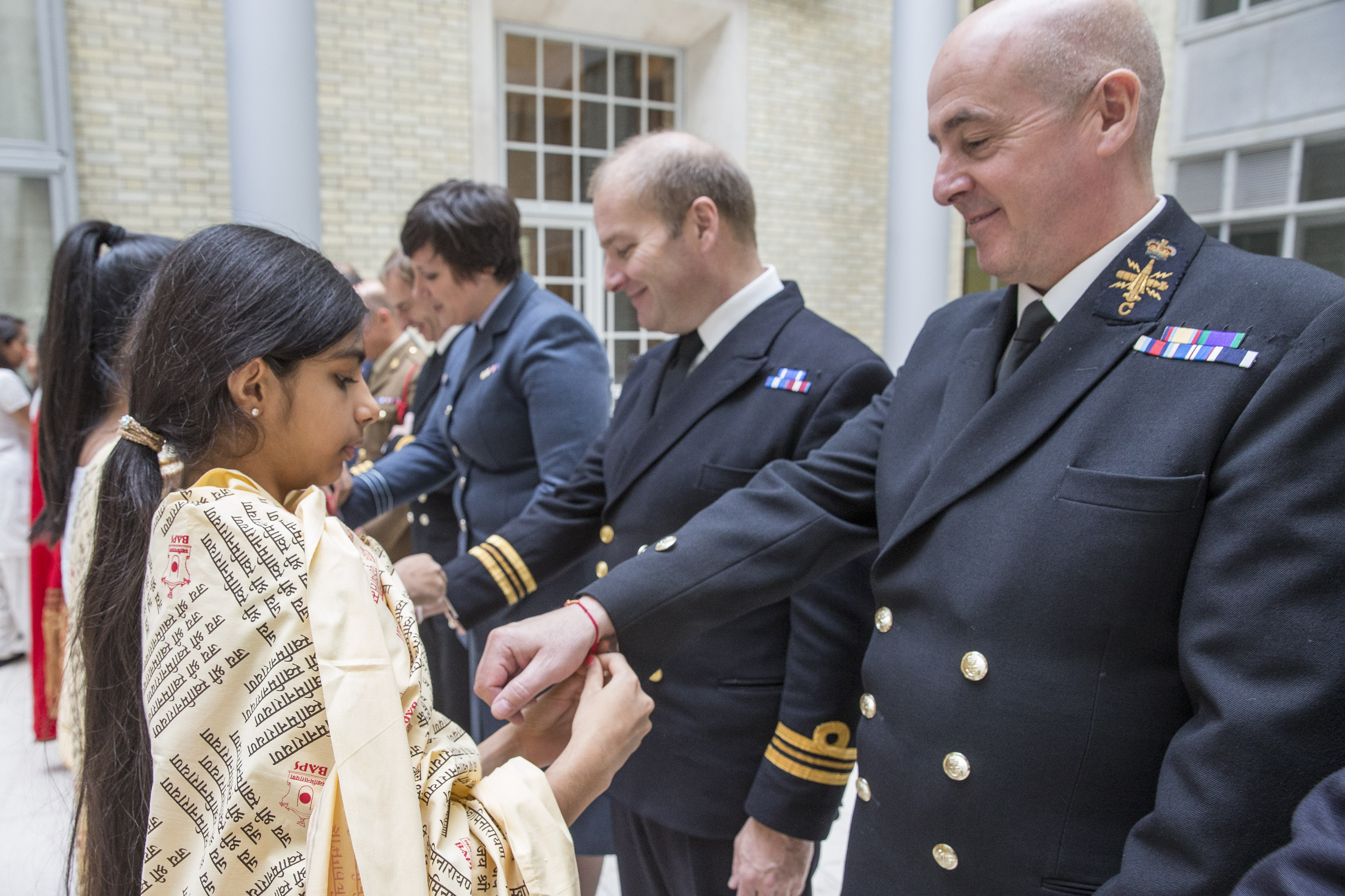 The young girls tying Rakhi to the Officials. PC: www.asiansunday.co.uk