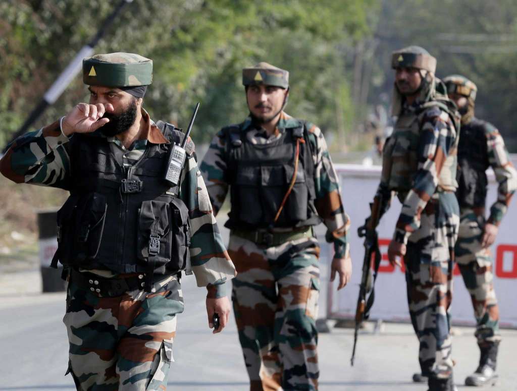Indian army soldiers guard outside the base camp which was attacked by suspected militants at Baramulla, northwest of Srinagar, Indian controlled Kashmir,