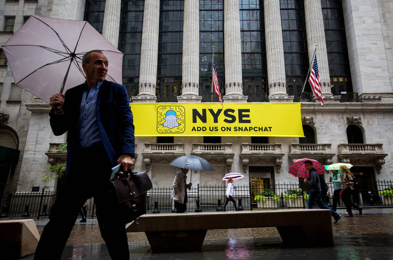 Pedestrians walked past a Snapchat sign outside of the New York Stock Exchange last month in Manhattan. Credit Michael Nagle/Bloomberg