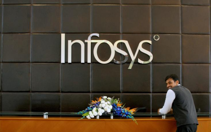 An employee of Infosys stands at the front desk of its headquarters in Bengaluru, India.