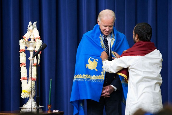 Vice President Joe Biden is presented with a shawl after lighting the candle at the Diwali reception in the South Court Auditorium of the White House, Nov. 13, 2012. (Official White House Photo by David Lienemann)