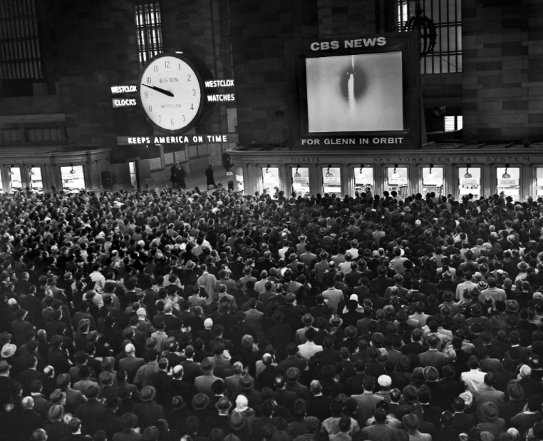 Commuters filled the concourse of Grand Central Terminal to watch as Glenn became the first American to orbit Earth.
