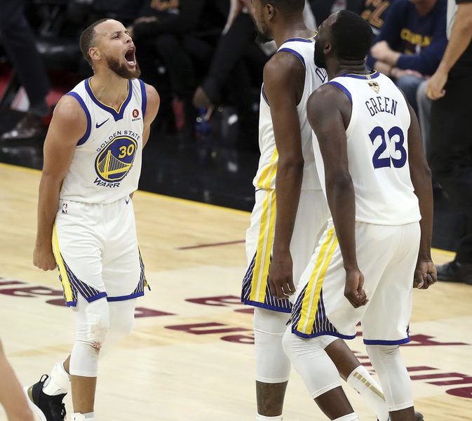 Golden State Warriors’ Kevin Durant celebrates with Stephen Curry, left, and Draymond Green (23) during the second half of Game 3 of basketball’s NBA Finals against the Cleveland Cavaliers, Wednesday, June 6, 2018, in Cleveland. The Warriors defeated the Cavaliers 110-102 to take a 3-0 lead in the series. (AP Photo/Carlos Osorio)
