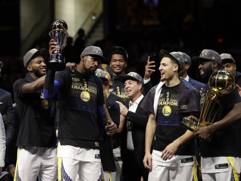 Golden State Warriors’ Kevin Durant, second from left, celebrates after the Warriors defeated the Cleveland Cavaliers 108-85 in Game 4 of basketball’s NBA Finals to win the NBA championship, Friday, June 8, 2018, in Cleveland. (AP Photo/Tony Dejak)