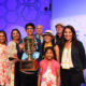 Karthik Nemmani surrounded by family, holding his Championship Trophy (Photo: Scripps Spelling Bee)